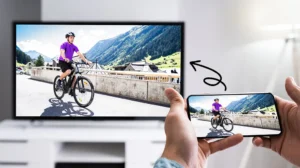 Smartphone avec l'icône Cast active et TV en arrière-plan